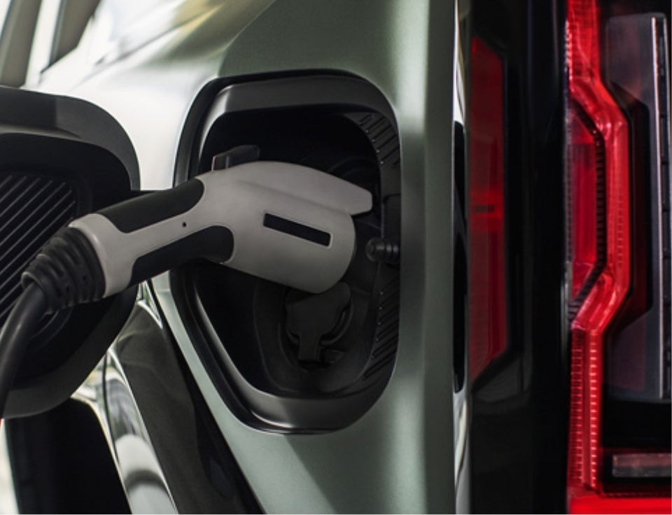 Close up of charging port with charger plugged in on a GMC Hummer EV SUV - Union Park Buick GMC in Wilmington DE