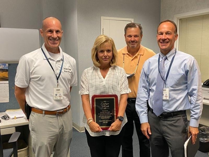 4 employees accepting an award