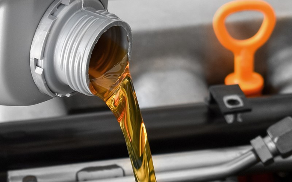 GMC oil change - oil pouring in car engine for oil change