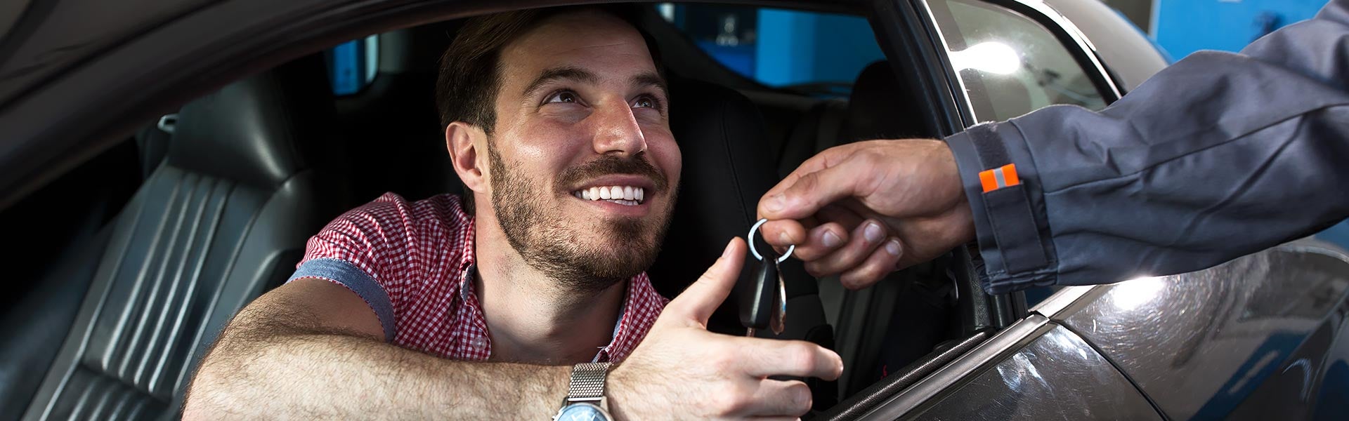 Man in a car taking keys
