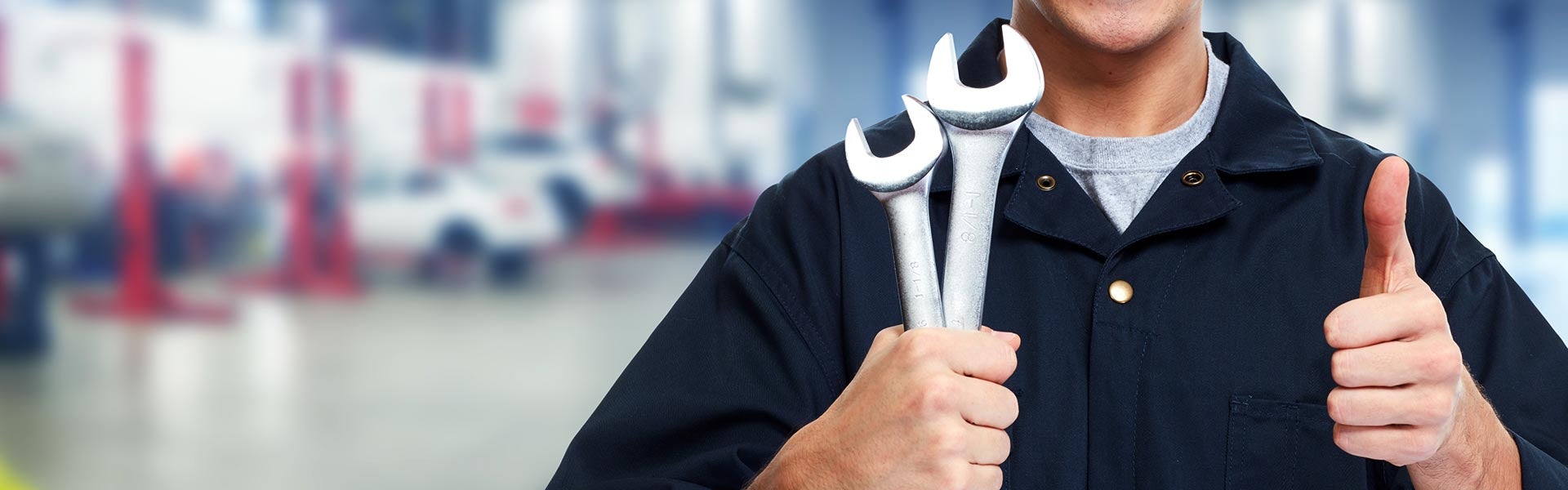 Mechanic holding two wrenches